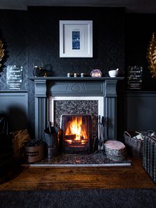 a vintage mantel in a moody living room