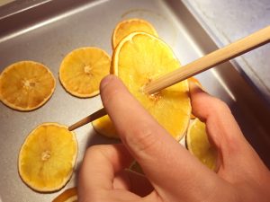 Poking holes in your dried oranges