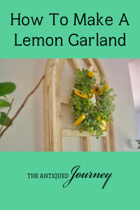 DIY lemon garland on a wreath displayed on an old window