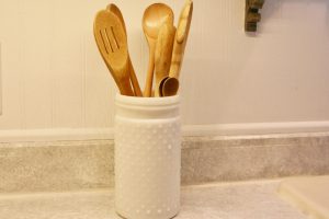 tall hobnail jar holding wooden spoons