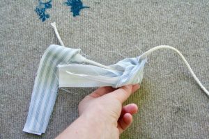 pulling ends of fabric through for ticking stripe fabric garland