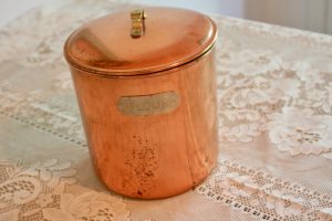 a copper jar with a lid with the word flour on it