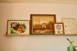 a picture rail displayed with vintage art