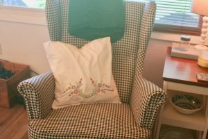 diy embroidered floral pillow on a houndstooth chair