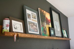 home decor displayed on a dark stained picture rail