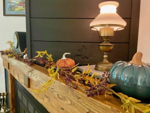 fall mantel decor with faux garland and pumpkins