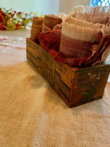 vintage wooden cheese box as storage for cloth napkins
