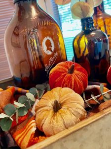 a vintage fall centerpiece with amber bottles