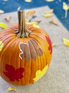leaf stencils on a pumpkin