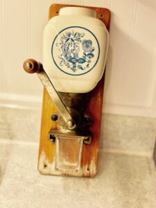 an antique wall mount coffee grinder