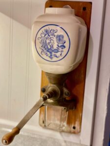 an antique Delft wall mount coffee grinder