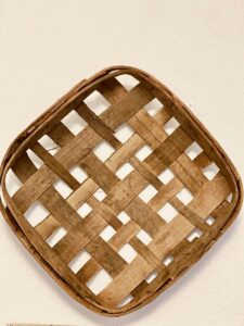 a vintage tobacco basket on a wall