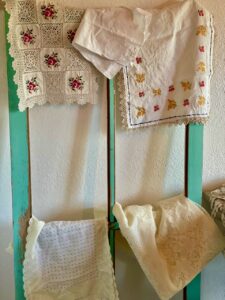 vintage linens displayed on an old window
