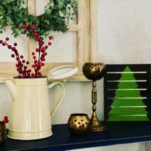 brass candlesticks displayed with vintage enamelware for Christmas