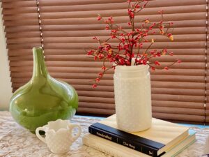 a vignette of vintage books and glassware