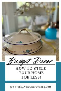 a vintage ironstone tureen styled with ribbon on a shelf