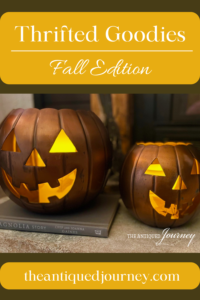 a photo of some thrifted copper jack-o-lanterns on a hearth