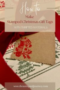 a stamped gift tag for Christmas with a red birdhouse 