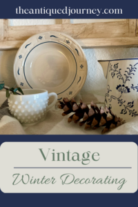 a shelf decorated with a vintage winter vignette