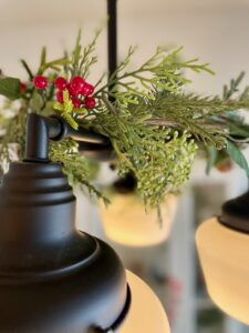 chandelier Christmas decor with a garland and red berries