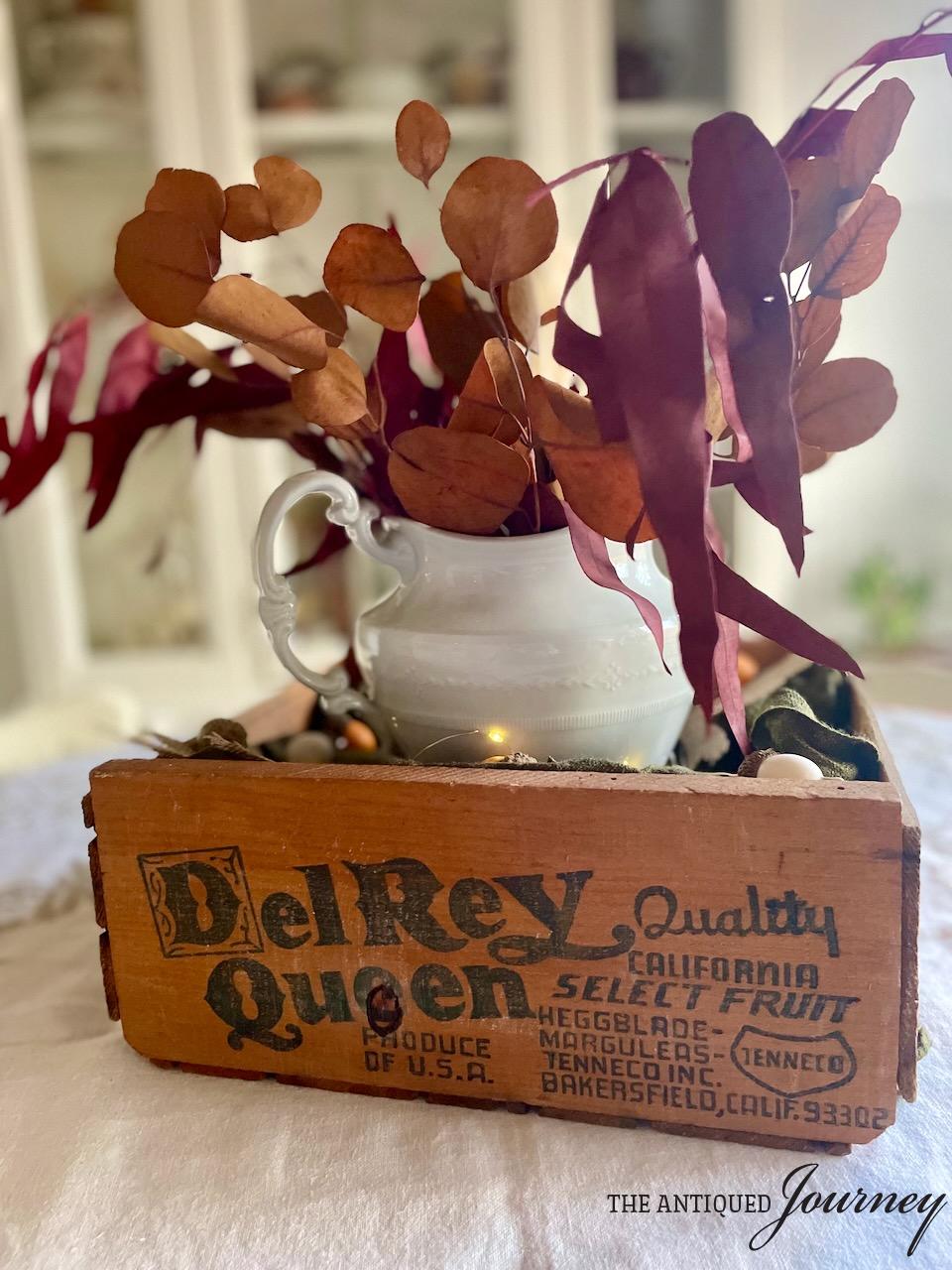 a thanksgiving centerpiece with a thrifted wooden crate