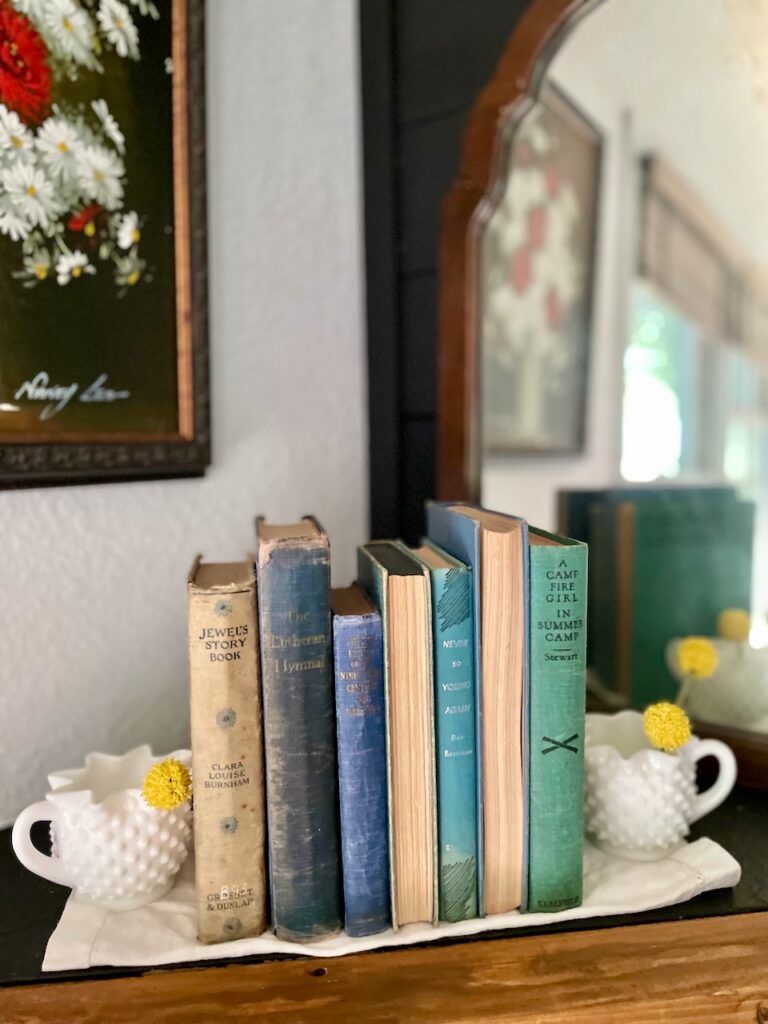 a mantel with a row of vintage blue books for Summer decor