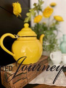 a vintage yellow enamel teapot used for Summer decor