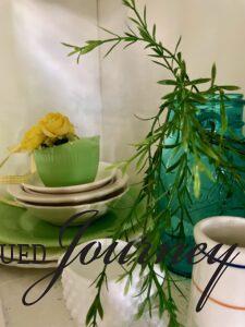 a vintage blue glass jar with greenery 