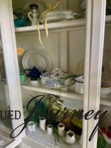 a hutch styled for Summer with vintage decor