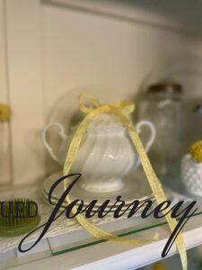 summer decor styled in a hutch with vintage items
