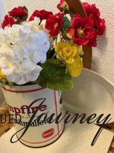 faux flowers in a vintage marshmallow tin for a patriotic display