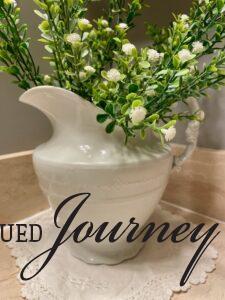 antique ironstone pitcher styled on a bathroom counter