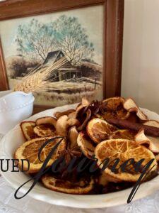 homemade fall potpourri with fruit and cinnamon sticks