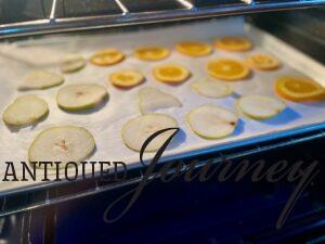 orange and pear slices drying in oven 