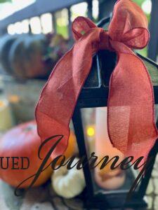 orange ribbon tied on an outdoor lantern for fall