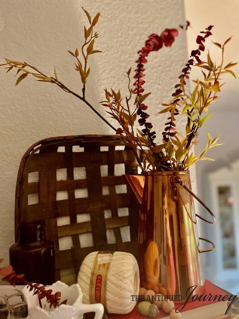 vintage copper floral arrangement for fall with a tobacco basket