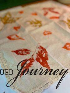 leaf stamped images onto a cloth napkin for fall