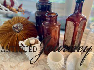 vintage amber bottles and milk glass for fall shelving