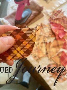 squeeze hot glue on to plaid paper leaf to create a Thanksgiving thankfulness tree