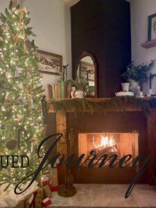 Christmas tree with white lights with fireplace in evening