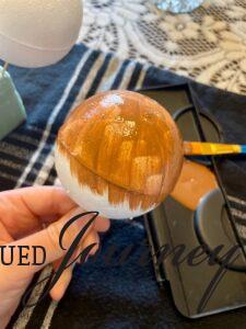 painting foam balls brown for DIY Christmas ornaments