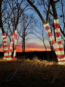 candy cane Christmas lights lit up at sunset