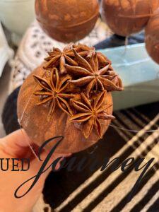 glueing star anise to a foam ball for eco-friendly and natural Christmas ornaments