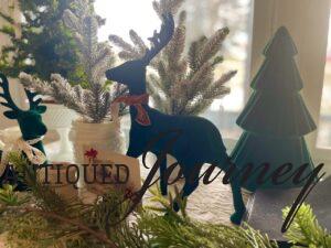 green velvet deer and small flocked trees with vintage decor for a Christmas display