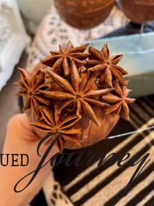 keep gluing star anise on a natural DIY Christmas ornament 