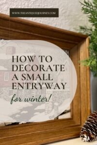 vintage decor and natural elements styled on a shelf in an entryway for winter