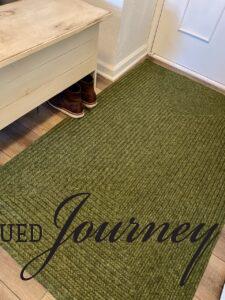 a green woven entryway rug for winter