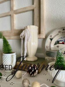 vintage books styled with milk glass for winter decor