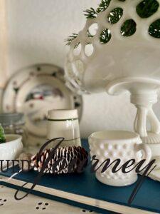 vintage books used in a winter display with milk glass