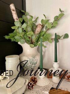 milk glass taper candle holders styled on a mantel for winter